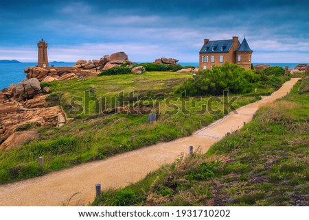 Amazing Atlantic ocean coastline with granite stones and cute lighthouse, Ploumanach, Brittany, France, Europe