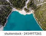Amazing autumn landscape of Lago di Braies Lake in italian Dolomites mountains in north Italy. Drone aerial photo with beautiful reflection in calm water in the morning. Pragser Wildsee, South Tyrol.