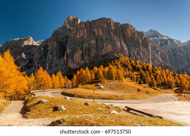 Amazing autumn scenery of the Sella group (Gruppo del Sella, Sellagruppe) with alpine road serpentine on foreground. Dolomite Alps, South Tyrol, Italy.
