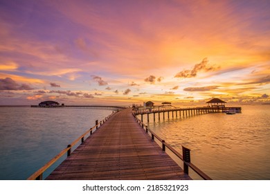 Amazing beach landscape. Beautiful Maldives sunset seascape view. Horizon colorful sea sky clouds, over water villa pier pathway. Tranquil island lagoon, tourism travel background. Exotic vacation - Shutterstock ID 2185321923