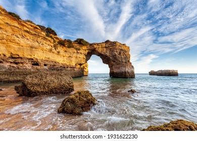 Amazing beach at sunrise. Algarve is located in the south of Portugal and is a vacation destination for many tourists. Your stone arch is an excellent spot for photographers and spearfishing