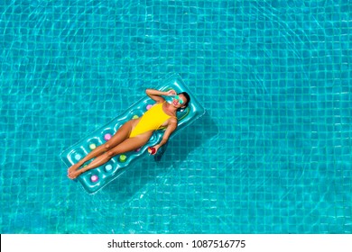 Amazing Beautiful Girl In A Yellow Bikini Air Mattress Swims In The Pool Of A Luxury Hotel, Summer Vacation, Happiness, Travel, Smile Joy, Listening To Music, Drinking Cocktail, Top View