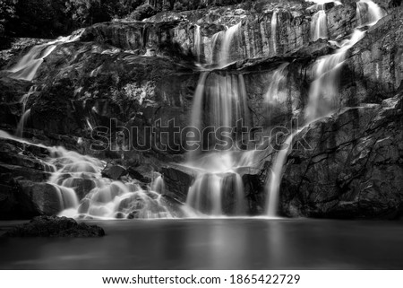 Amazing black and white Scenery of Sungai Pandan Water Fall. Sungai Pandan Waterfall located 25 km from Kuantan town at Pahang.  Motion blur and soft focus due to Long Exposure Shot. low key effect.