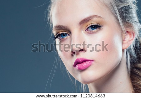 Amazing blonde woman with pink lipstick young female over gray blue background