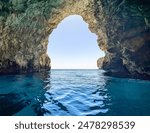 Amazing blue waters of the Mediterranean Sea in Blue Grotto from a boat. The Blue Grotto is sea caverns on the south east coast of Malta