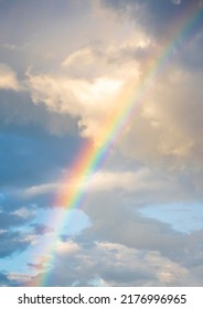 amazing bright rainbow in beautiful evening blue cloudy sky after rain and thunder with flash sun light streaming thruogh the clouds, weather thunderstorm concept