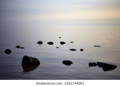 Amazing calm scenery of a blue sky and tranquil sea with light fog above, selective focus. High quality photo