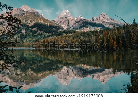 Amazing calm water reflections on Taggart Lake in Grand Teton National Park, Wyoming, USA in the summer. 