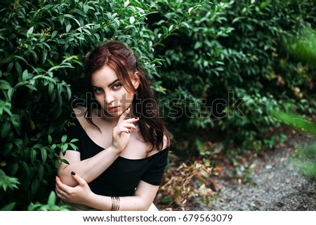 Similar – Young redhead woman surrounded by plants