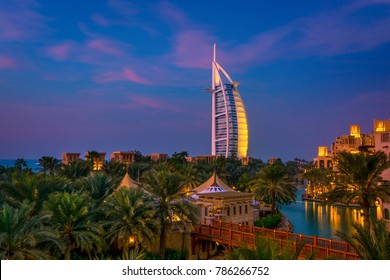 Amazing Cityscape with beautiful park with palm trees and hotels on a sunset in Dubai, UAE