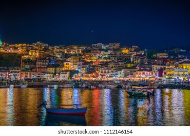 Amazing Cityscape View Of Parga City, Greece During The Summer. Long Exposure HDR Photography With Beautiful Architectural Colorful Buildings Illuminated At Night Near The Port Of Parga Epirus, Greece