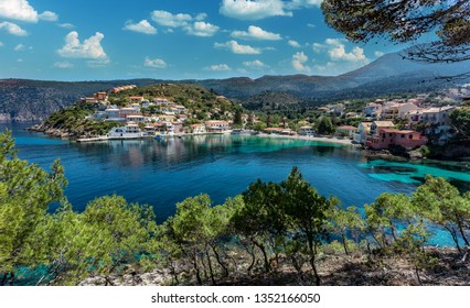 Amazing coastline with colorful houses under sunlight. Wonderful summer seascape with perfect blue sky of Ionian Sea. Assos village. Kefalonia. Greece - Shutterstock ID 1352166050