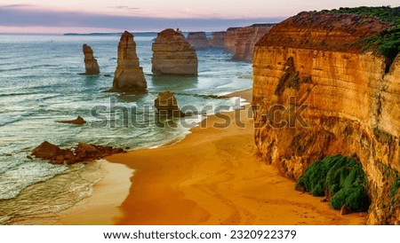 Amazing coastline of the Twelve Apostles, collection of limestone stacks off the shore of Port Campbell National Park, by the Great Ocean Road in Victoria, Australia at sunset.