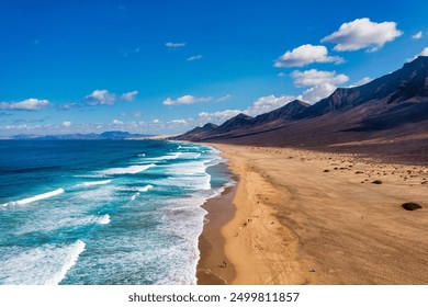 Amazing Cofete beach with endless horizon. Volcanic hills in the background and Atlantic Ocean. Cofete beach, Fuerteventura, Canary Islands, Spain. Playa de Cofete, Fuerteventura, Canary Islands. - Powered by Shutterstock