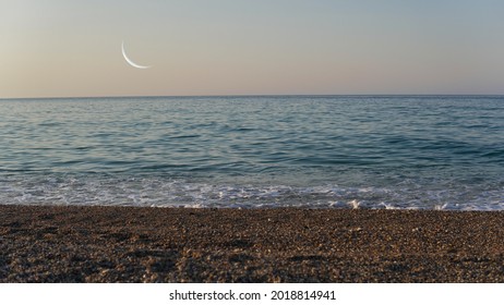 Amazing combination of beach sea and crescent moon.Crescent moon over the sea. Great view away from the city to relax. Amazing skyline.
