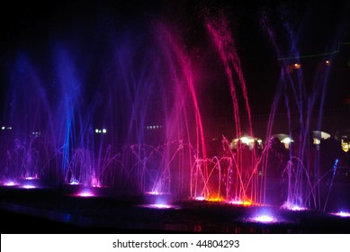 amazing dancing fountain in night illuminated red and blue colors