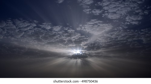 Amazing dawn with sunrays through the clouds