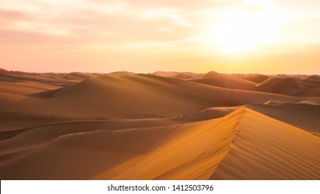 Amazing desert sunset. Beautiful Arabian desert with warm colors. Colorful contours of sand dunes at Abu Dhabi. 