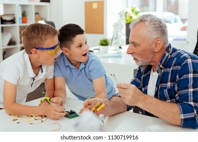 Amazing Facts. Curious Surprised Boys Looking At Their Teacher While Being Amazed By New Knowledge