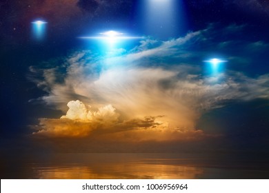 Amazing fantastic background - extraterrestrial aliens spaceship fly above sea, ufo with blue spotlights in red glowing sky. Elements of this image furnished n