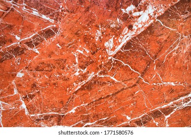 Amazing Fiery View On A Background Of Red Granite Stone With White Veins. The Surface Of Natural Red Granite, Polished Crystalline And Texture, Mineral Stone Closeup, Macro.