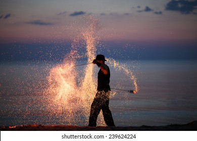 Amazing fire dance on the beach; fire sparks