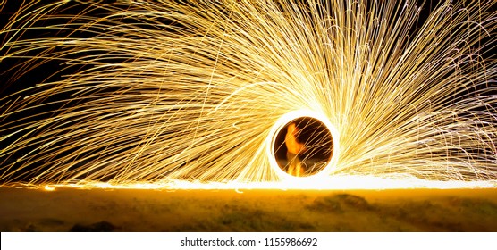 Amazing Fire Show At Night At Festival Or Wedding Party. Fire Dancers Swing, Spinning Fire And Man Juggling With Bright Sparks In The Night. Fire Show Performance And Entertainment