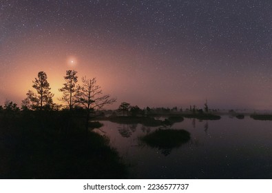 Amazing Glowing Stars Effects Above Landscape. Milky Way Galaxy In Night Starry Sky Above Rural Landscape In Summer Season. Real Colorful Night Stars Above Swamp. Natural Starry Sky Above Landscape.