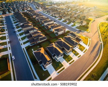 Amazing Golden Sunrays Aerial Sunrise Over New Development Suburban Homes in North Austin Texas House after house after house on neighborhood 