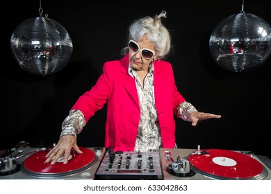 An Amazing Grandma DJ, Older Lady Djing And Partying In A Disco Setting