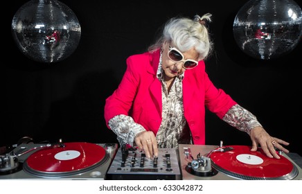 An Amazing Grandma DJ, Older Lady Djing And Partying In A Disco Setting