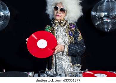 An Amazing Grandma DJ, Older Lady Djing And Partying In A Disco Setting