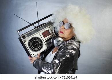 an amazing grandma DJ, older lady with a ghettoblaster, partying in a disco setting
