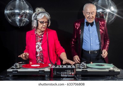 An Amazing Grandma And Grandpa, Older Couple Djing And Partying In A Disco Setting