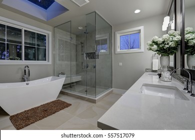 Amazing gray master bathroom with large glass walk-in shower, freestanding tub and skylights on the ceiling. Northwest, USA - Shutterstock ID 557517079