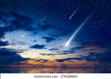 Amazing heavenly image with beautiful glowing sunset, comet and shooting stars, rising crescent moon and bright stars above sea. Elements of this image furnished by NASA