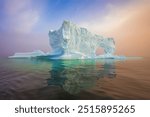 Amazing iceberg at sunset. Effect of climate change and global warming. Melting iceberg in Disko bay. Landscape photography of West Greenland. Floating ice in icefjord. Unesco world heritage