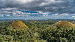 Amazing Landscape Of Bohol Island. Many Unique Karst Mountains, Covered With Brownish Vegetation, Stretch To The Horizon. Clouds In The Blue Sky. Philippines. Chocolate Hills Natural Monument. Carmen