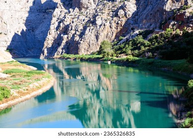 Amazing landscape of the Dark Canyon, with water reflection. The Dark Canyon is a canyon formed by the Euphrates River on the Munzur Mountains in the Kemaliye district of Erzincan province, Turkey. - Shutterstock ID 2365326835