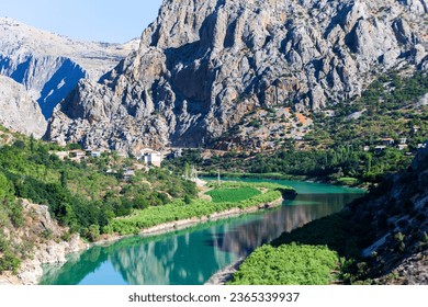 Amazing landscape of the Dark Canyon, with water reflection. The Dark Canyon is a canyon formed by the Euphrates River on the Munzur Mountains in the Kemaliye district of Erzincan province, Turkey. - Shutterstock ID 2365339937
