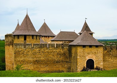 Amazing landscape photo of medieval castle with high stone walls, defensive towers and main Gate. Blue sky background. Low perspective view. Famous touristic place and travel destination in Ukraine. - Shutterstock ID 2013221627
