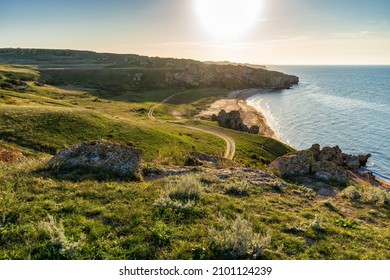 Amazing landscape with sea bay, sand beach and coastal hills and rocks on summer evening at sunset. Trip to seaside. Generalskie Plyazhi or coast of thousand bays. Karalarsky nature park, Crimea