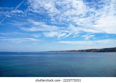 Amazing Landscape Seascape With Pacific Ocean Cliffs And Dramatic Cloud Cloudscape And White Boat. Perfect Travel Poster Background Western California San Diego