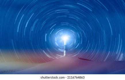 Amazing lighthouse in the hill of desert star trail in the background at sunset