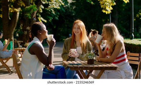 Amazing looking African lady and her friends multiracial enjoy the time at the patisserie while barista brings the fresh coffee - Powered by Shutterstock