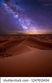 Amazing milky way over the dunes Erg Chebbi in the Sahara desert near Merzouga, Morocco , Africa. Beautiful sand landscape with stunning sky full of stars and night under a starry sky. After sunset
