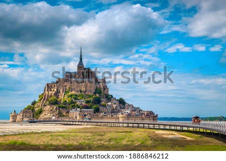 Amazing Mont Saint Michel cathedral on the rocky island and spectacular walkway on the bridge. Fantastic travel and touristic location, Normandy, France, Europe