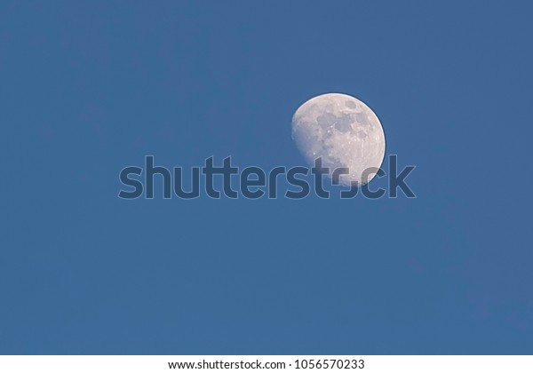 Amazing moon in the blue\
sky