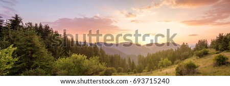 Amazing mountain landscape with colorful vivid sunset on the cloudy sky, natural outdoor travel background. Beauty world.