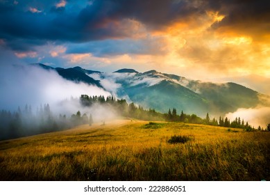 Amazing mountain landscape with fog and a haystack